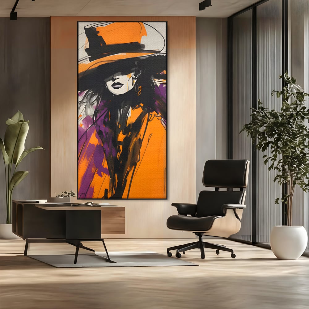 Tablou canvas cu ilustratie portret femeie cu palarie portocalie, in rama de aluminiu negru, pe perete intr-un birou